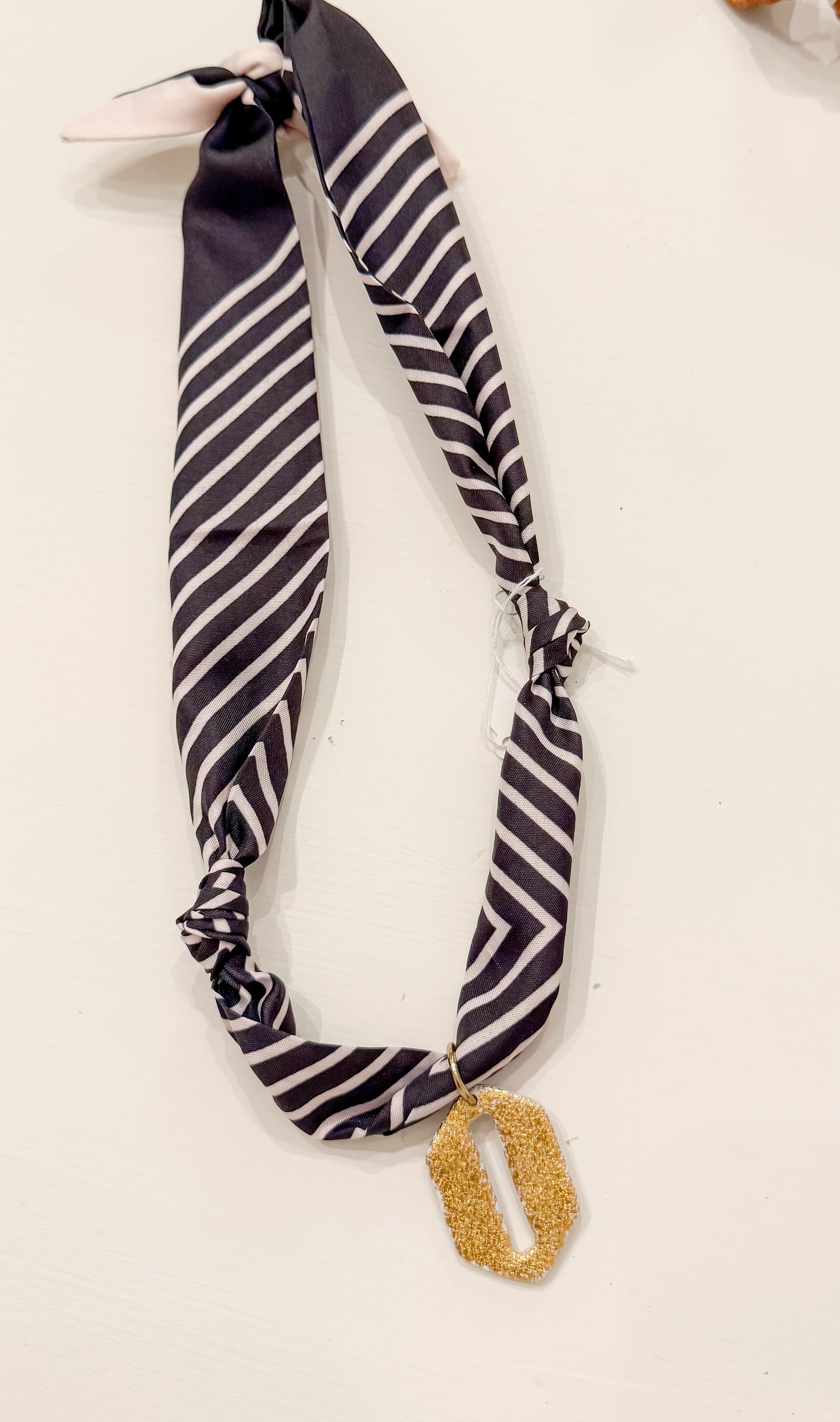 Black and white scarf w gold charm